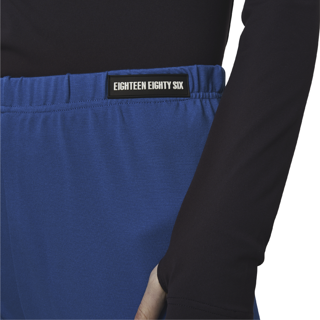Classic leggings in blue fabric featuring Eighteen Eighty-Six logo patch sewn at Elastic waistband. Open at ankle cuffs.