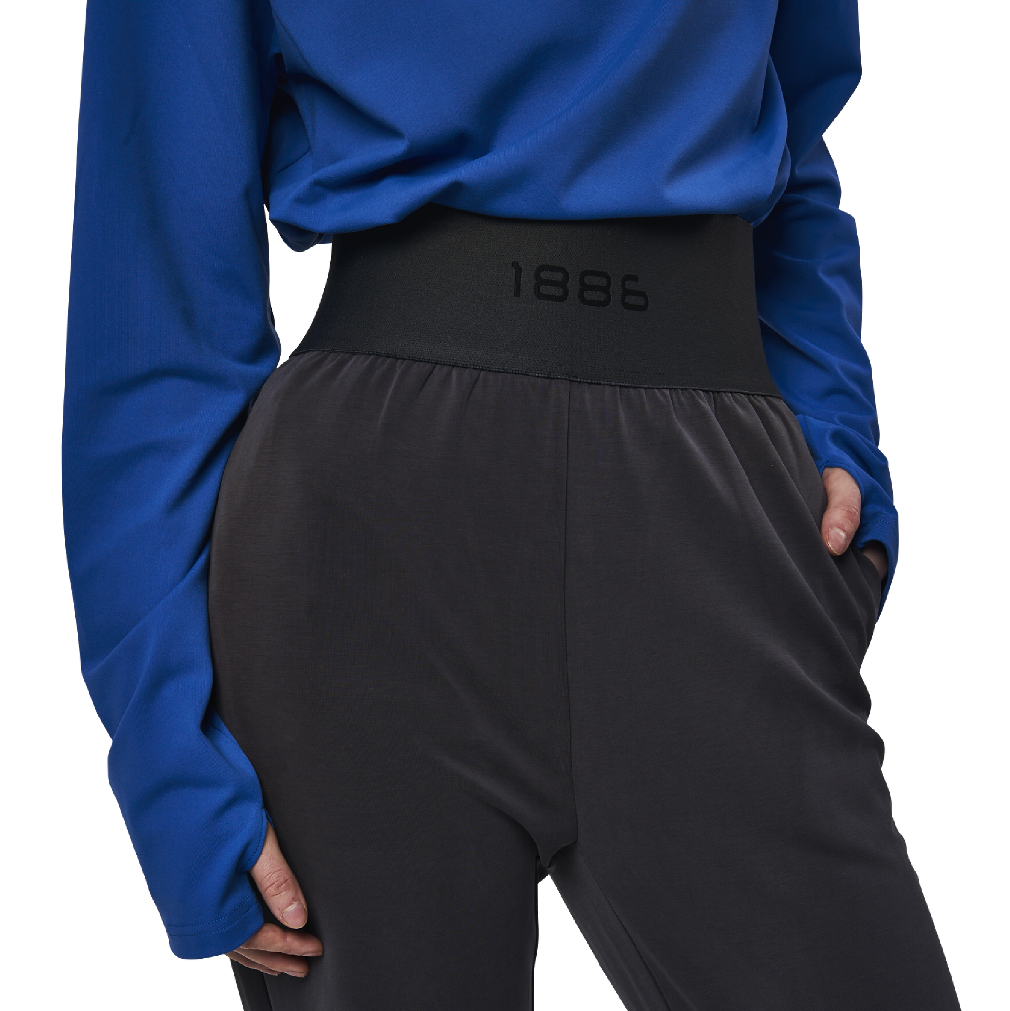 Classic wide leg cut pants in charcoal grey fabric featuring 1886 logo sewn at waist. Elastic waistband. High waist. Pockets at side.